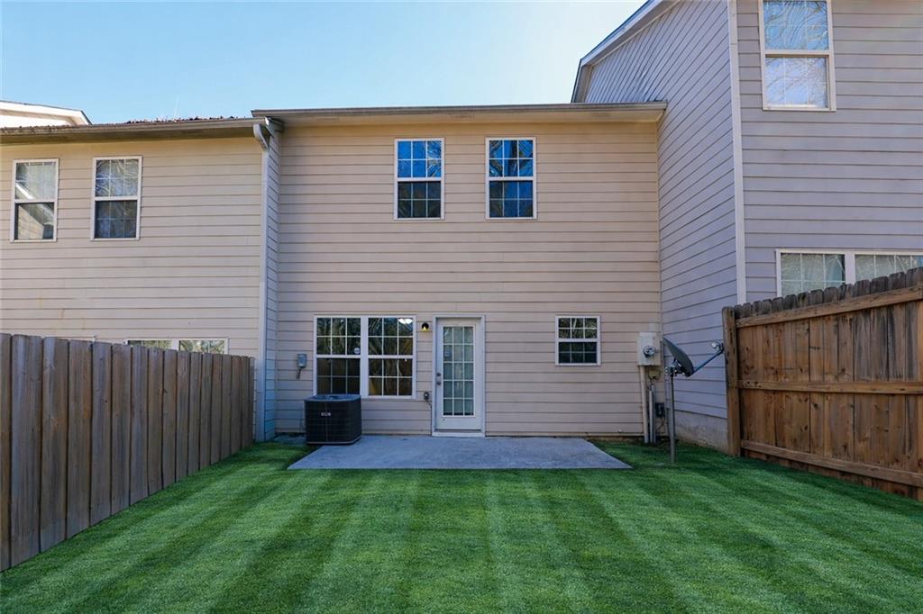 6926 Rogers Point Lithonia, GA 30058 - Photo 17 of 19 a front view of a house with a yard