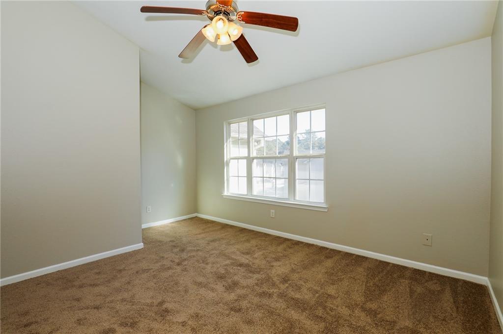 6926 Rogers Point Lithonia, GA 30058 - Photo 2 of 19 an empty room with windows and fan