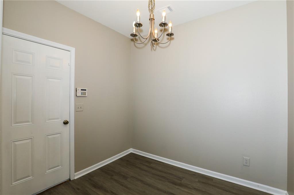 6926 Rogers Point Lithonia, GA 30058 - Photo 10 of 19 a view of a small space with wooden floor and a chandelier