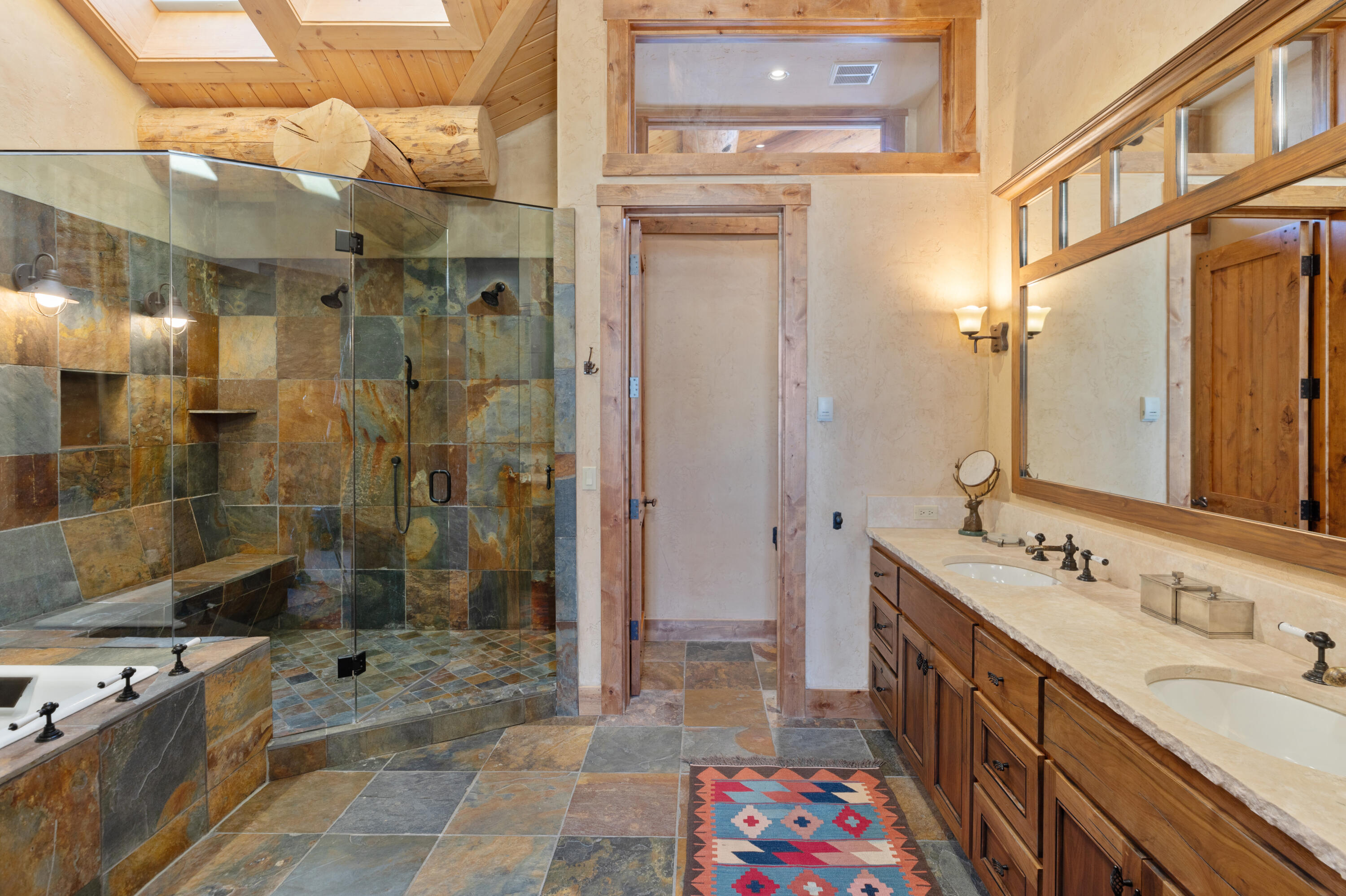 213 Josefa Lane Telluride, CO 81435 - Photo 18 of 35 a bathroom with a double vanity sink mirror double shower and a bathtub