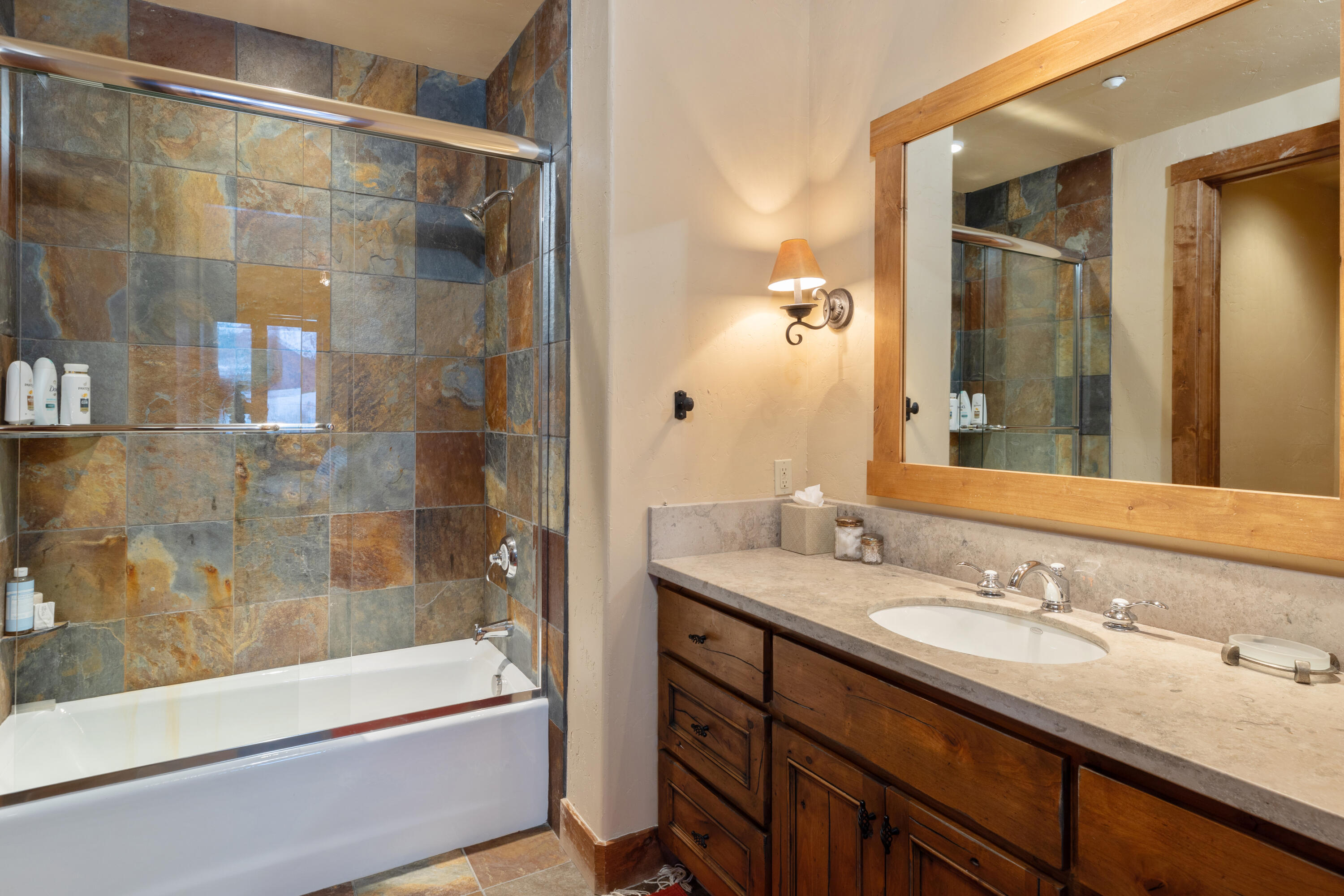 213 Josefa Lane Telluride, CO 81435 - Photo 26 of 35 a bathroom with a granite countertop sink mirror bathtub and shower