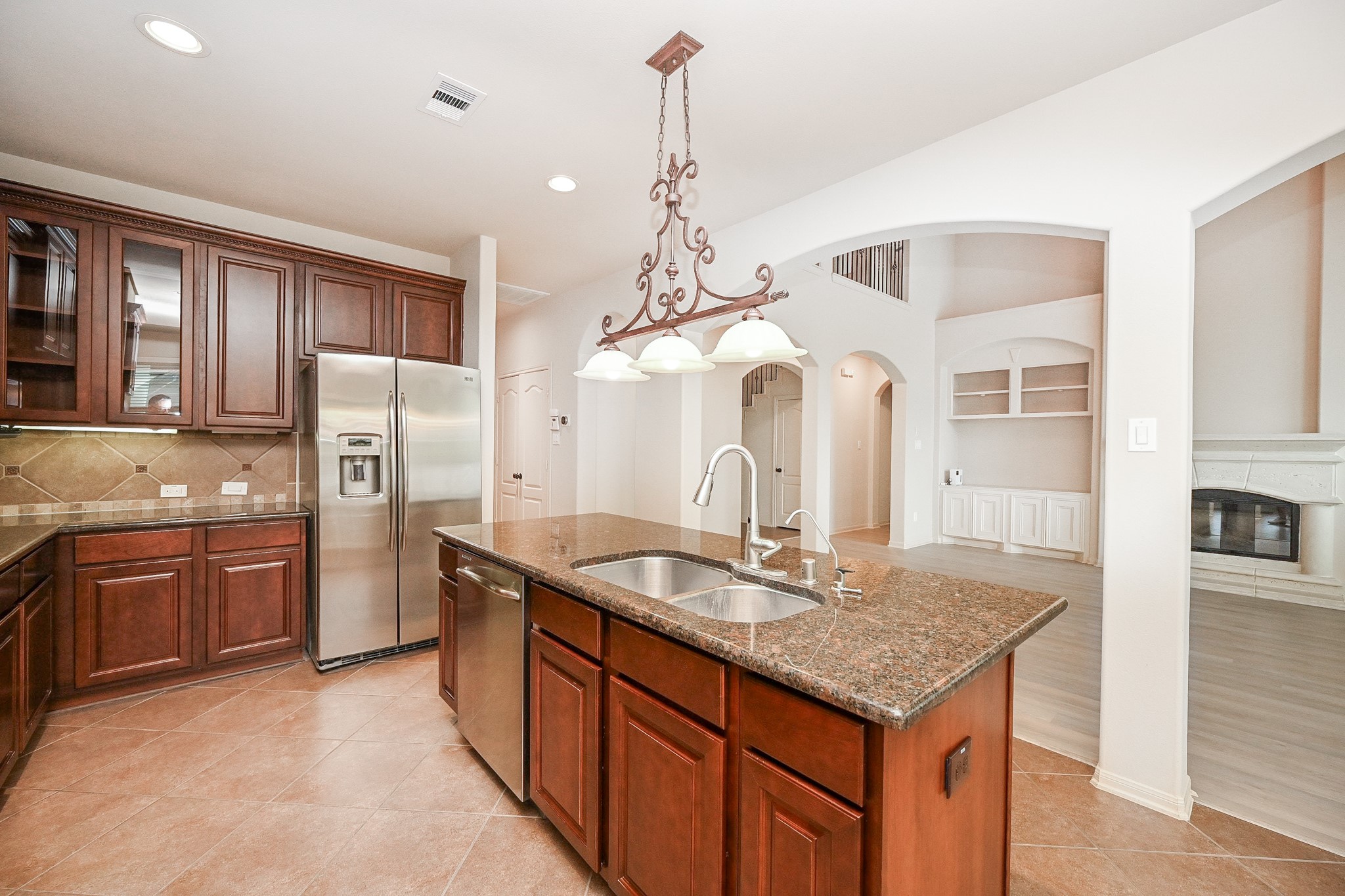 19 Sandwell Place Spring, TX 77389 - Photo 14 of 33 Kitchen featuring central island connecting seamlessly to the living room