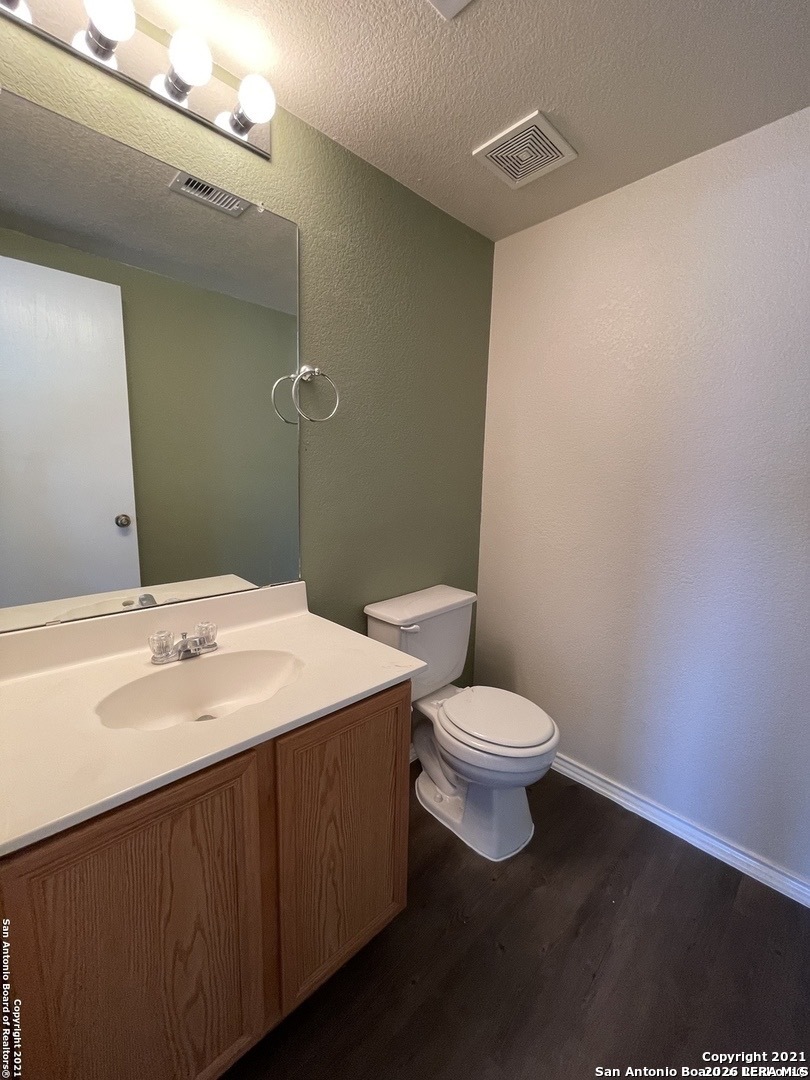 8927 Nature Trail Converse, TX 78109 - Photo 13 of 15 a bathroom with a toilet a sink and mirror