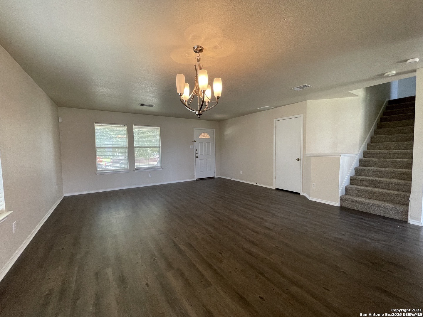 8927 Nature Trail Converse, TX 78109 - Photo 2 of 15 an empty room with wooden floor and windows