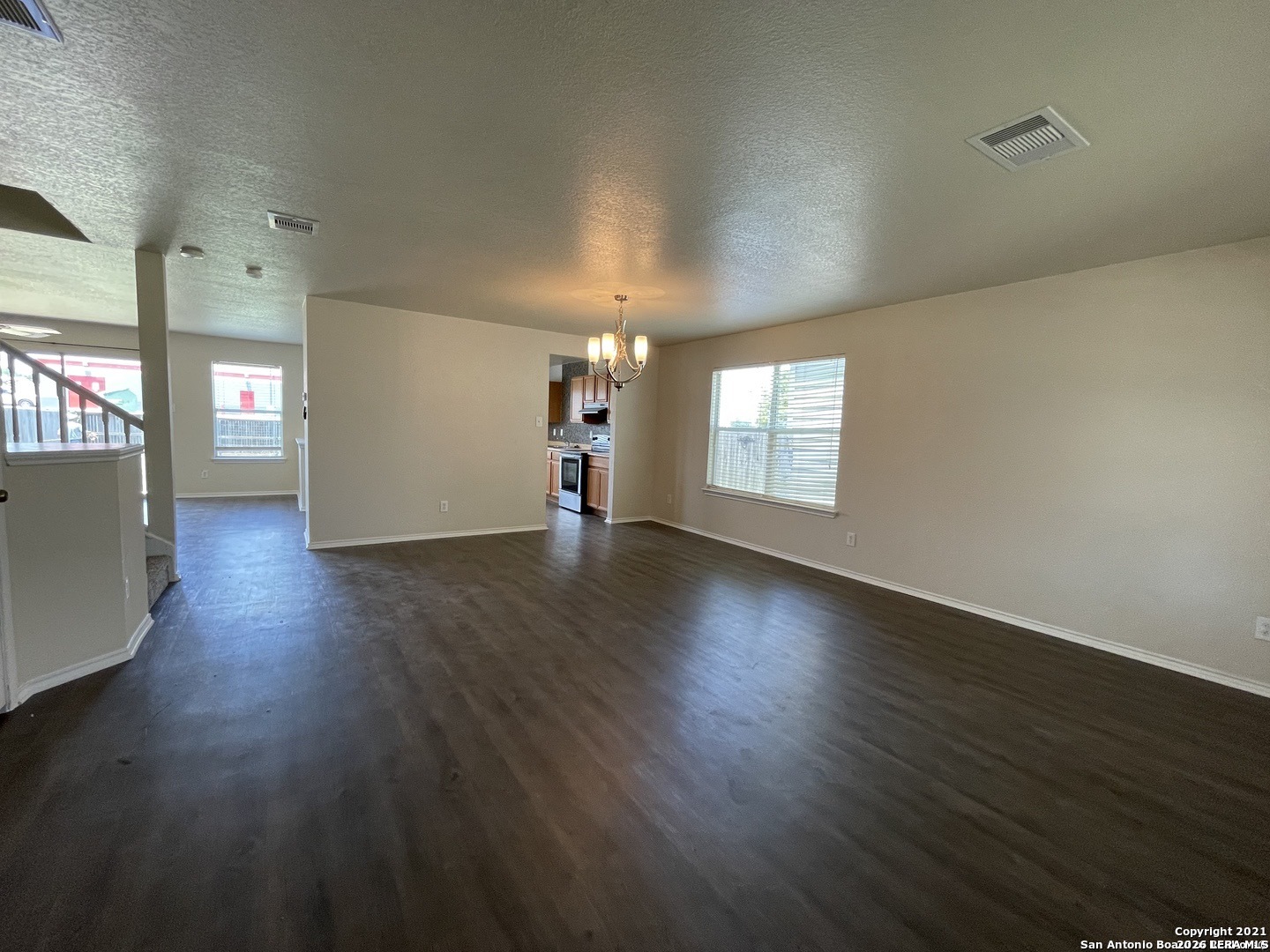 8927 Nature Trail Converse, TX 78109 - Photo 3 of 15 an empty room with wooden floor and windows