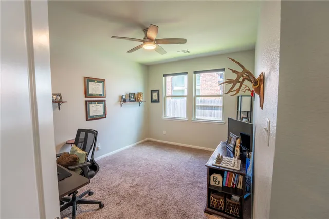 a view of workspace with windows and closet