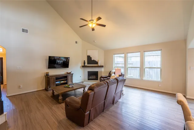 a living room with furniture fireplace and a flat screen tv