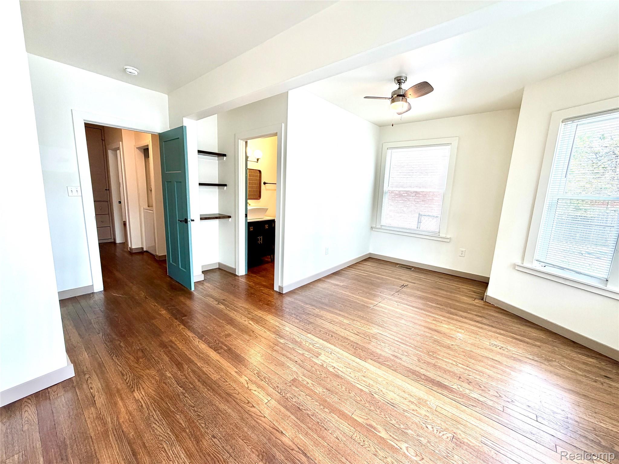 2045 Calvert Avenue Detroit, MI 48206 - Photo 29 of 41 Unfurnished bedroom featuring dark wood-type flooring, ensuite bathroom, and ceiling fan