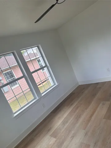 a view of an empty room and a window
