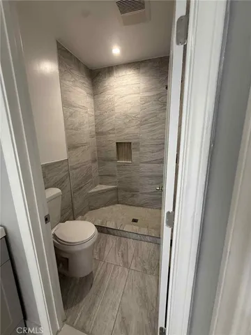a bathroom with a toilet and a shower