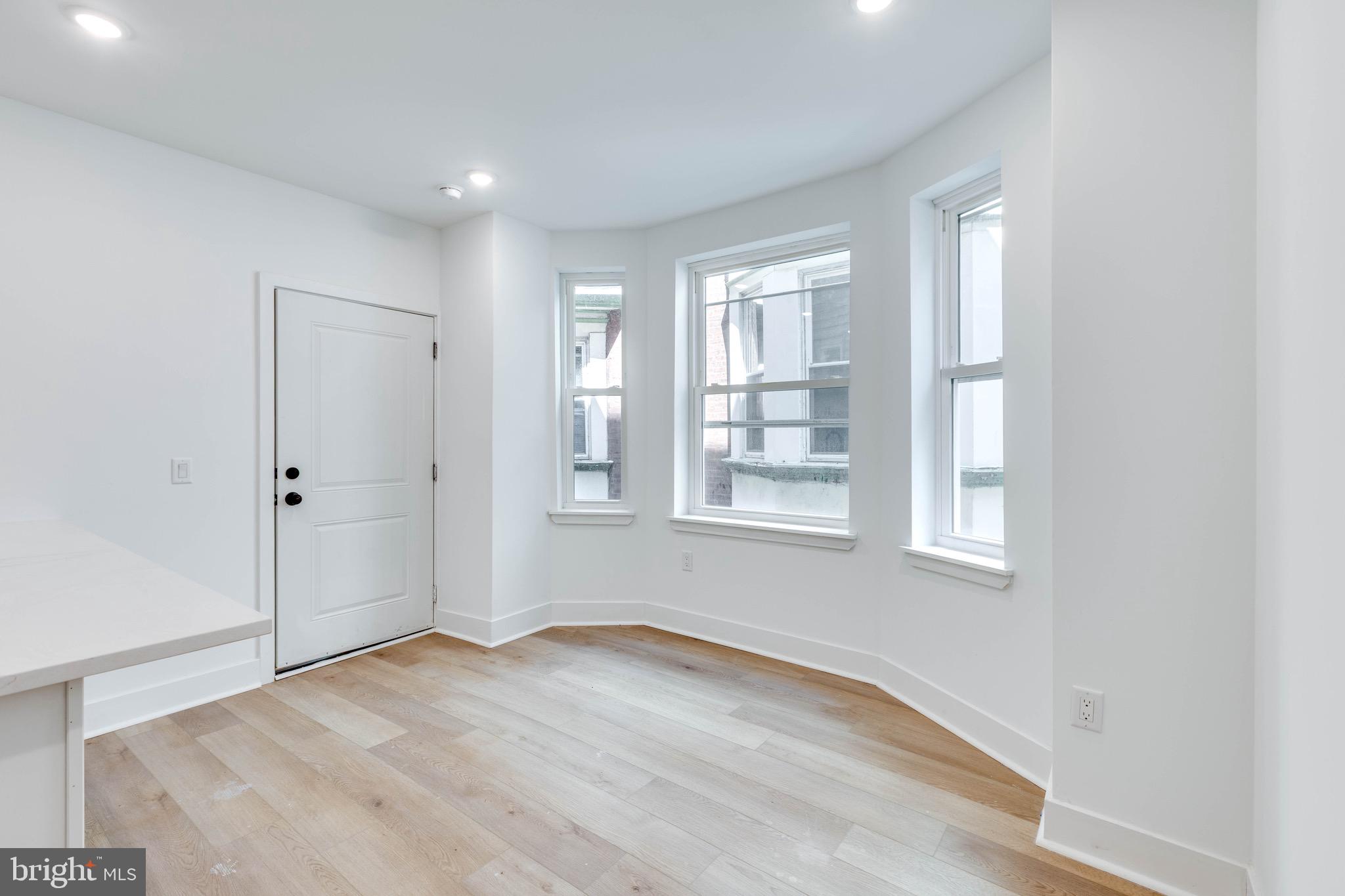 4220 Baltimore Avenue, Unit 2 Philadelphia, PA 19104 - Photo 3 of 11 an empty room with wooden floor and windows