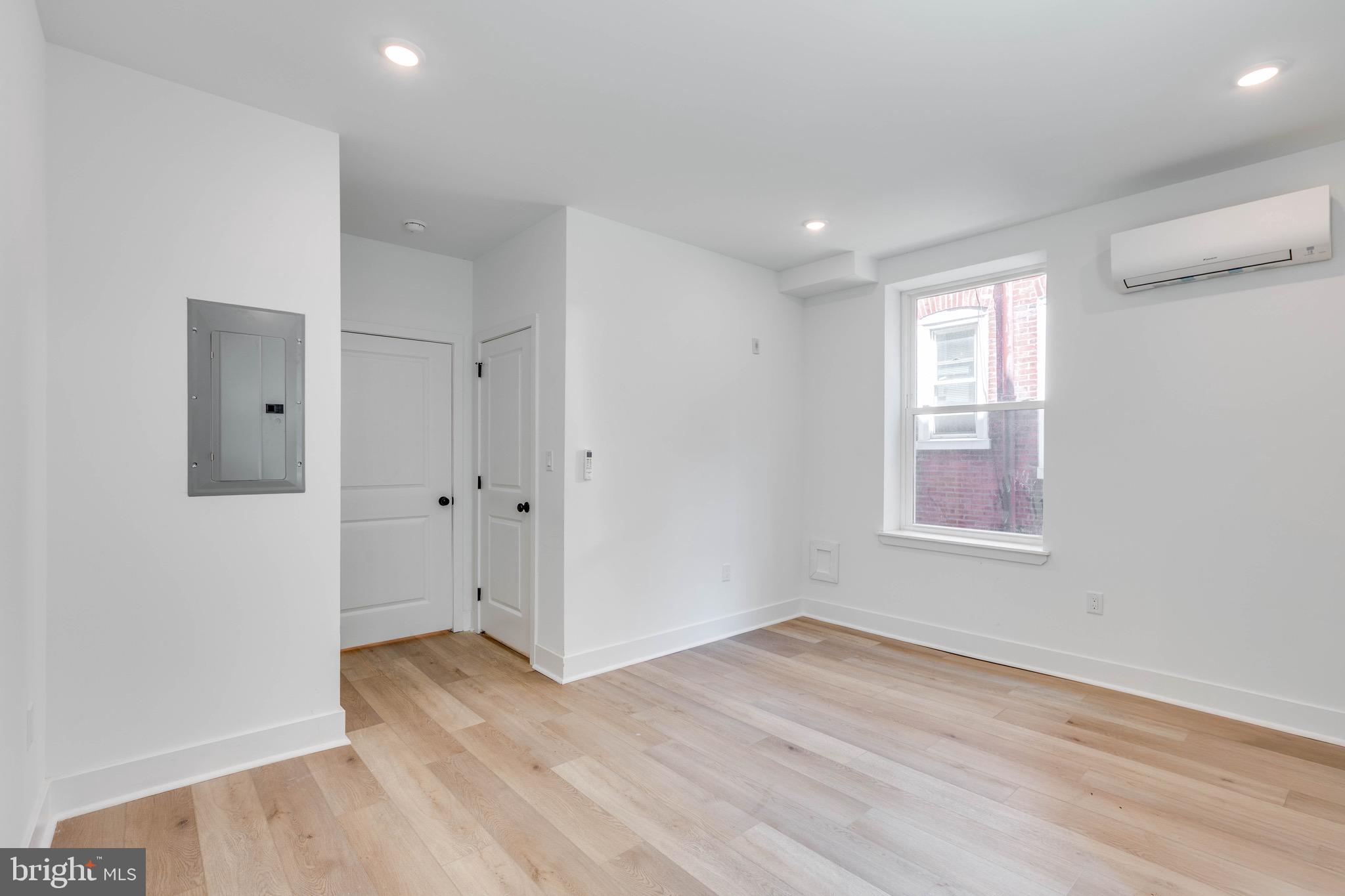 4220 Baltimore Avenue, Unit 2 Philadelphia, PA 19104 - Photo 7 of 11 a view of an empty room with wooden floor and a window