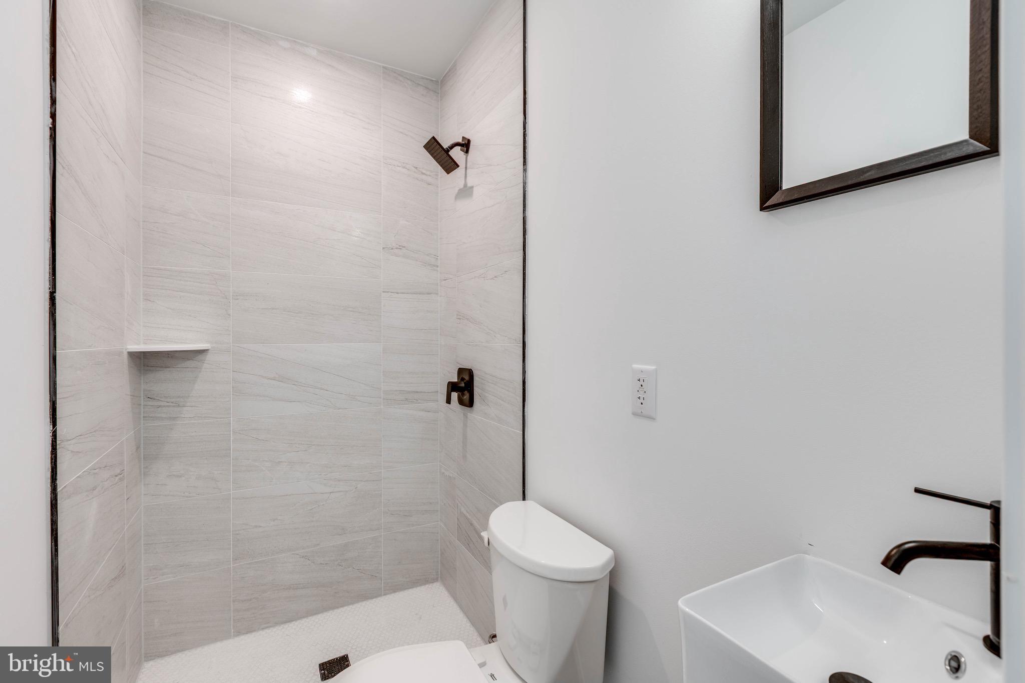 4220 Baltimore Avenue, Unit 2 Philadelphia, PA 19104 - Photo 8 of 11 a bathroom with a sink and a toilet