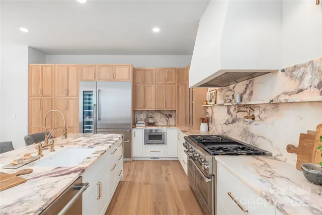 a kitchen with a stove a sink and a refrigerator