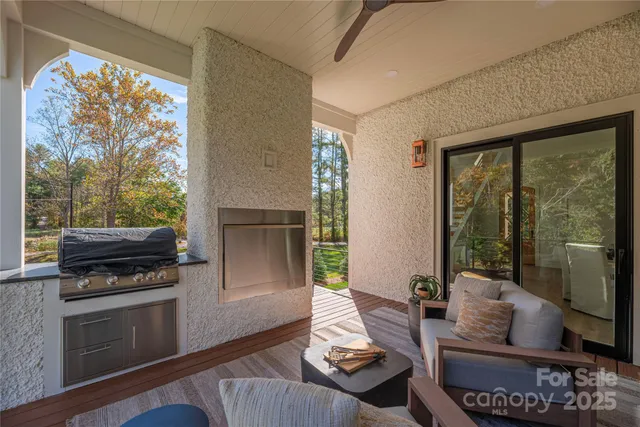 a living room with furniture and a floor to ceiling window