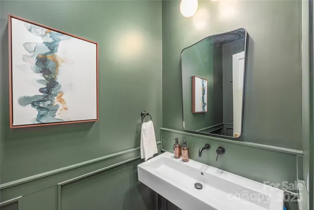 a bathroom with a sink mirror and vanity