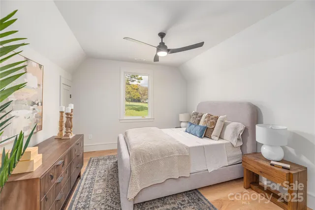 a bedroom with a bed window and couch