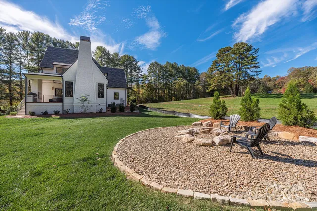 a view of a house with backyard sitting area and garden