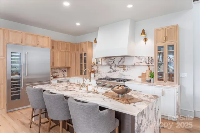 a kitchen with a table chairs stove and cabinets