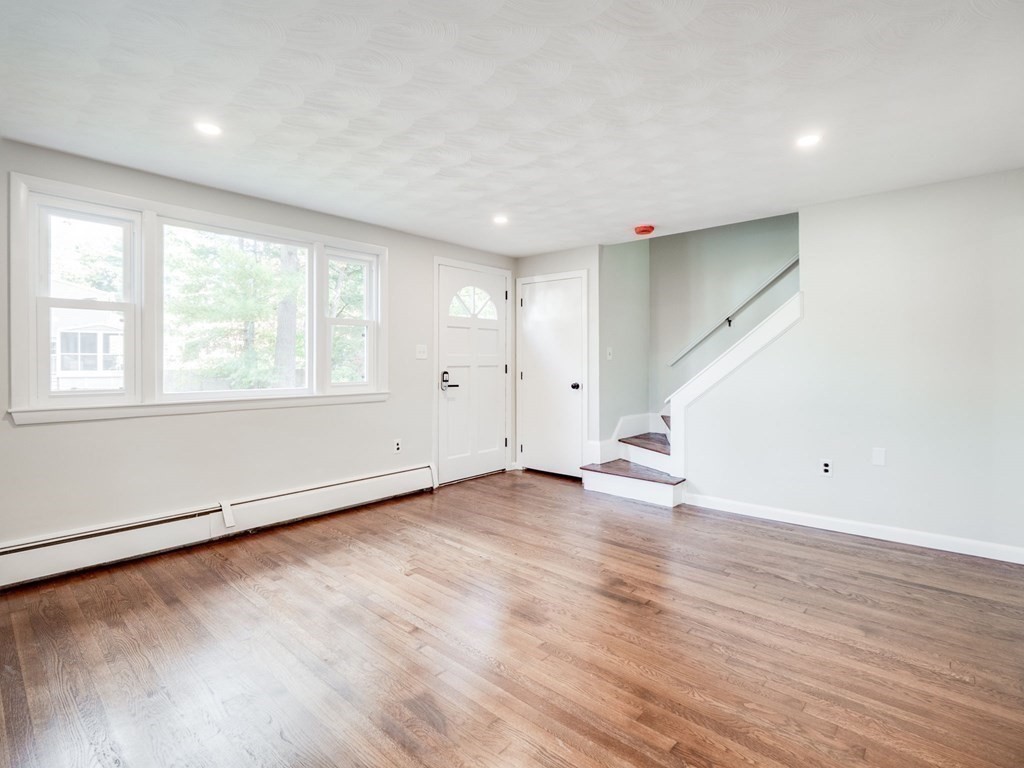 116 Arkansas Road Tewksbury, MA 01876 - Photo 13 of 38 an empty room with wooden floor and windows