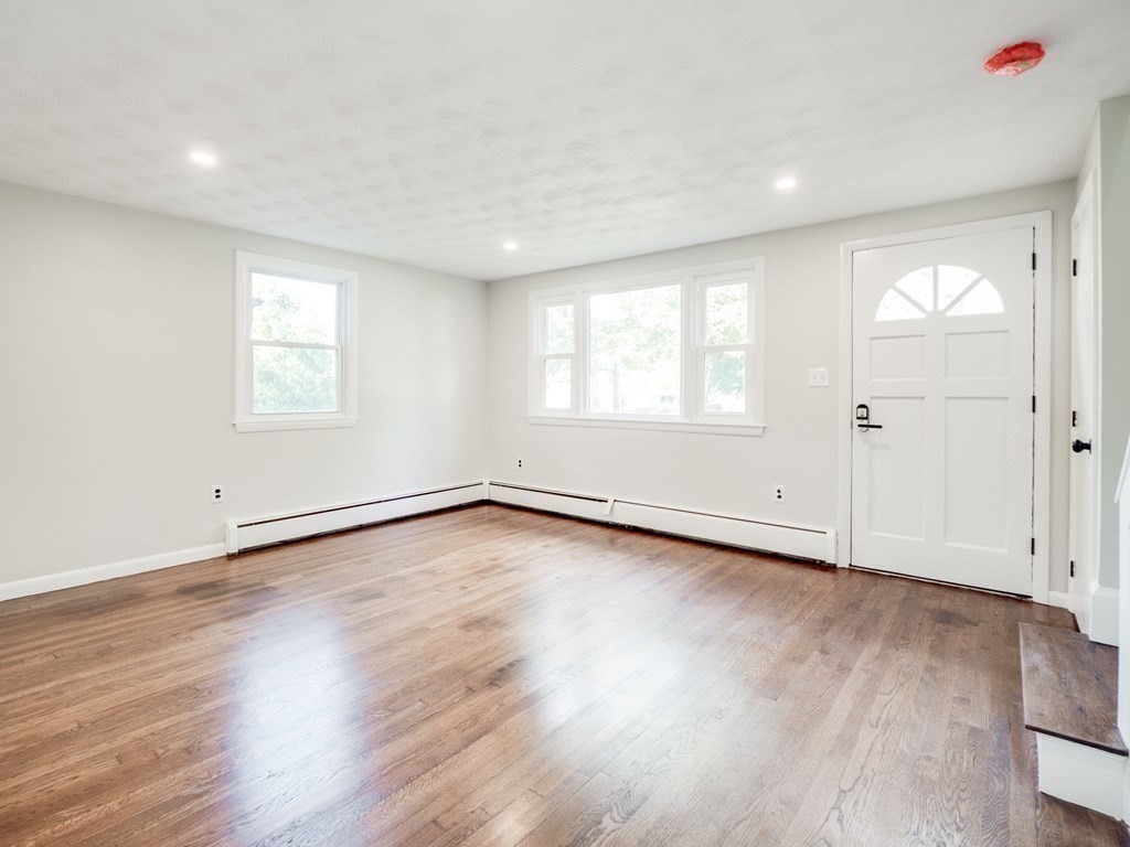 116 Arkansas Road Tewksbury, MA 01876 - Photo 14 of 38 an empty room with wooden floor and window