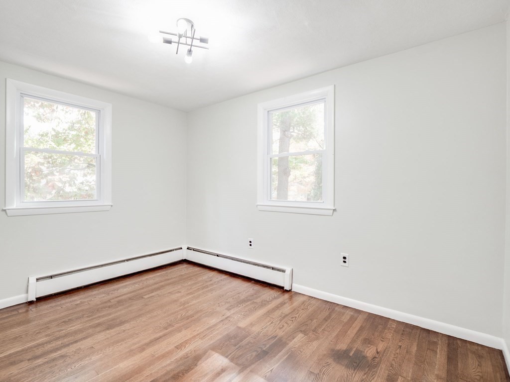 116 Arkansas Road Tewksbury, MA 01876 - Photo 15 of 38 an empty room with wooden floor and windows