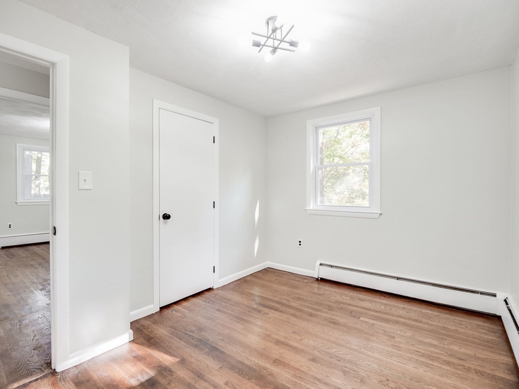 116 Arkansas Road Tewksbury, MA 01876 - Photo 19 of 38 wooden floor in an empty room with a window