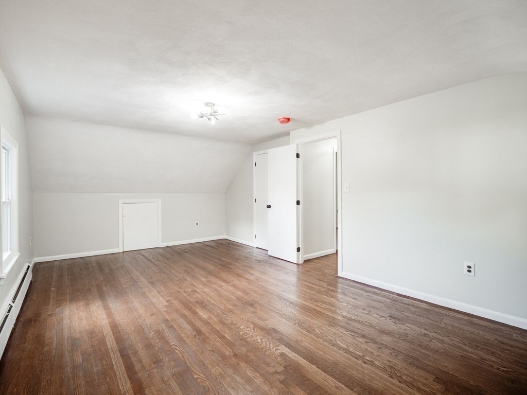 116 Arkansas Road Tewksbury, MA 01876 - Photo 22 of 38 an empty room with wooden floor and windows
