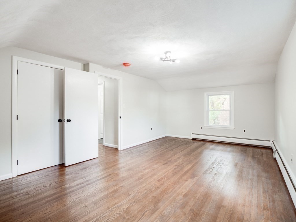 116 Arkansas Road Tewksbury, MA 01876 - Photo 23 of 38 an empty room with wooden floor and window