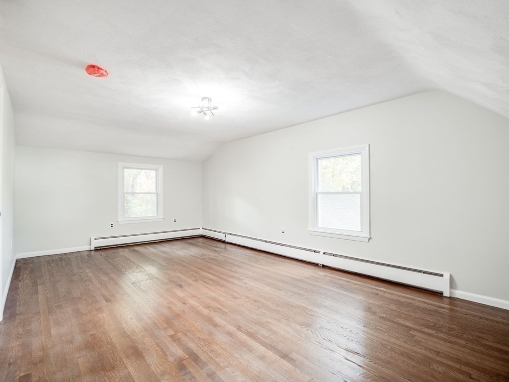 116 Arkansas Road Tewksbury, MA 01876 - Photo 24 of 38 an empty room with wooden floor and windows