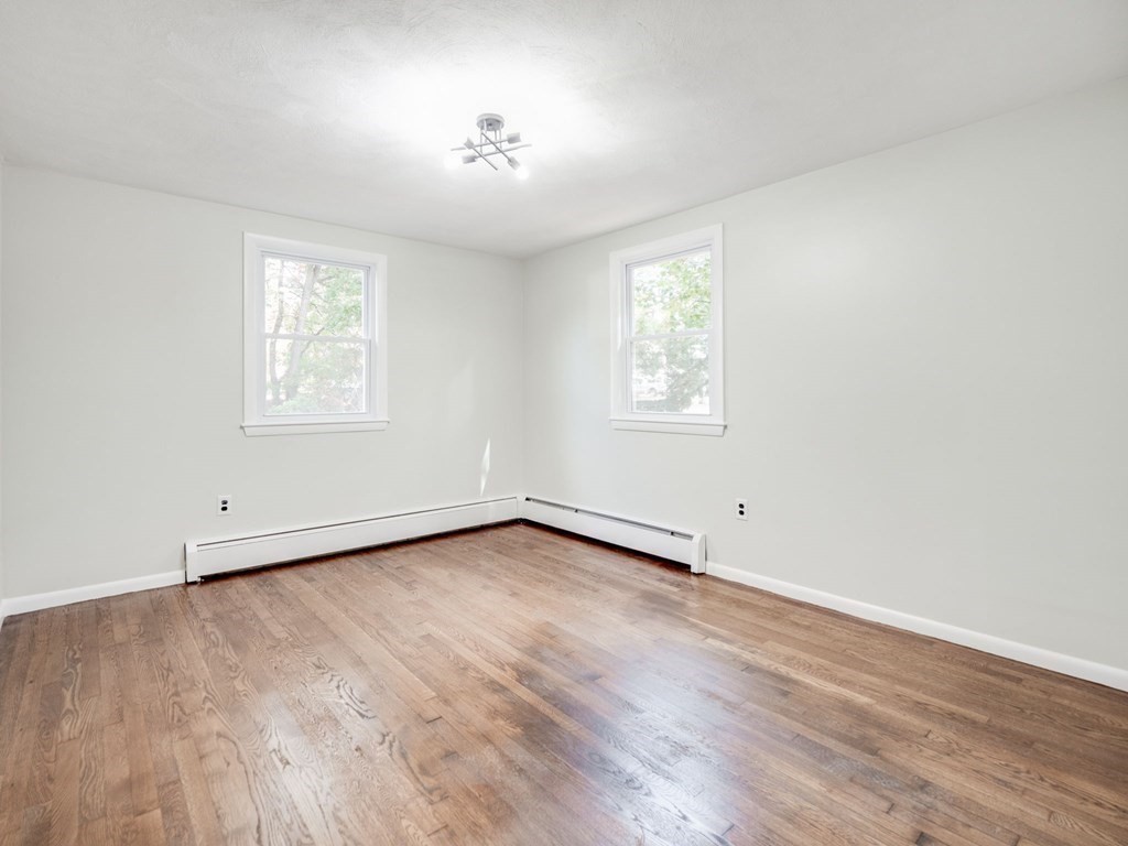 116 Arkansas Road Tewksbury, MA 01876 - Photo 26 of 38 an empty room with wooden floor chandelier and windows
