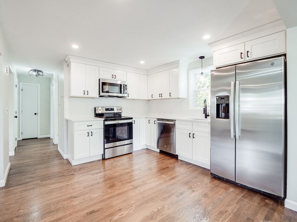 116 Arkansas Road Tewksbury, MA 01876 - Photo 3 of 38 a kitchen with stainless steel appliances granite countertop a refrigerator and a stove top oven