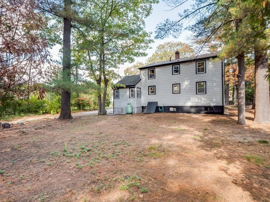 116 Arkansas Road Tewksbury, MA 01876 - Photo 34 of 38 a view of a house with backyard and a tree