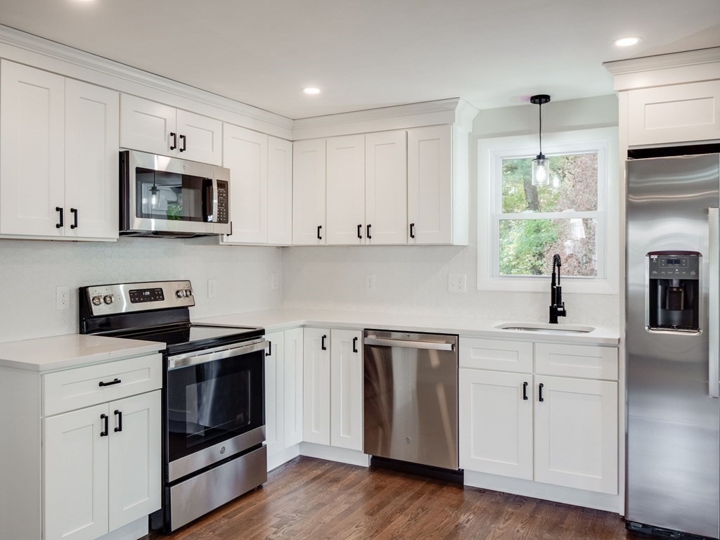 116 Arkansas Road Tewksbury, MA 01876 - Photo 4 of 38 a kitchen with cabinets stainless steel appliances and wooden floor