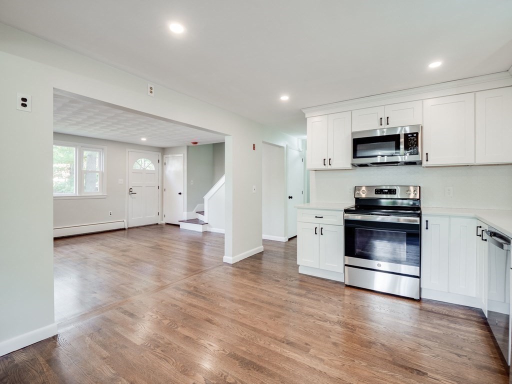 116 Arkansas Road Tewksbury, MA 01876 - Photo 6 of 38 a kitchen with granite countertop a stove and a refrigerator