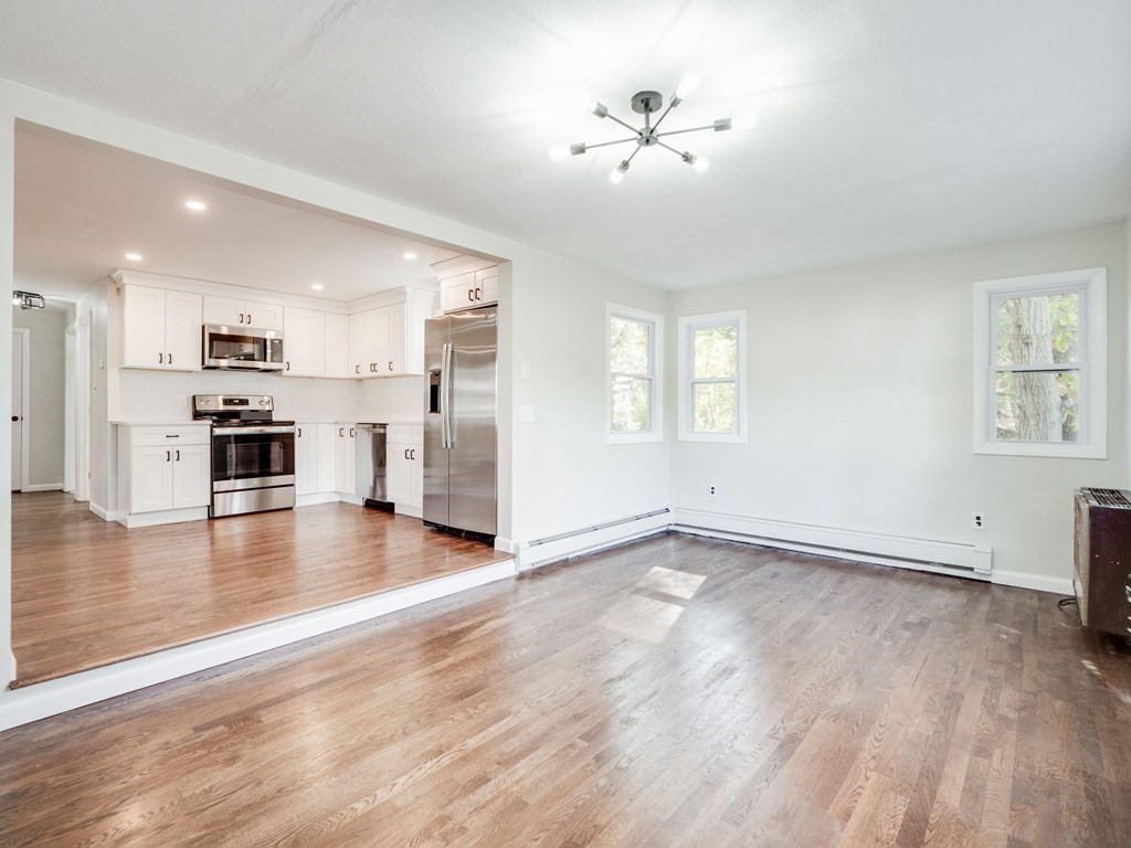 116 Arkansas Road Tewksbury, MA 01876 - Photo 7 of 38 an empty room with wooden floor and windows