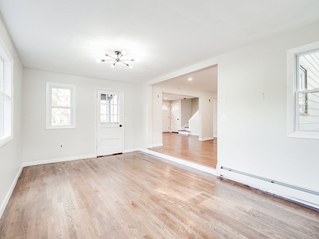 116 Arkansas Road Tewksbury, MA 01876 - Photo 10 of 38 wooden floor in an empty room with a window