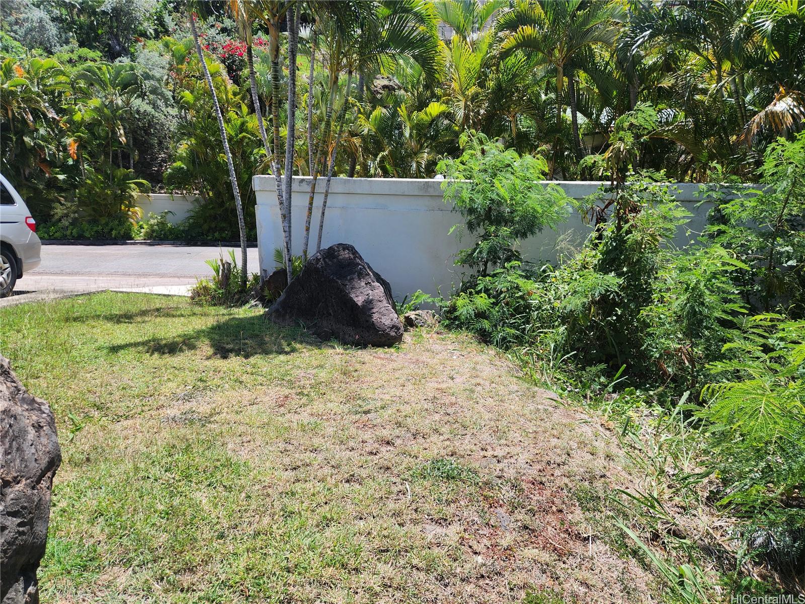 5442 Poola Street Honolulu, HI 96821 - Photo 10 of 13 a backyard of a house with a yard and outdoor seating