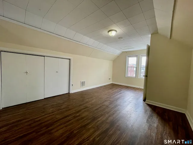 a view of an empty room and wooden floor