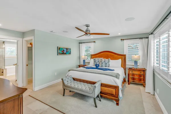 a bathroom with a granite countertop sink a toilet and a mirror