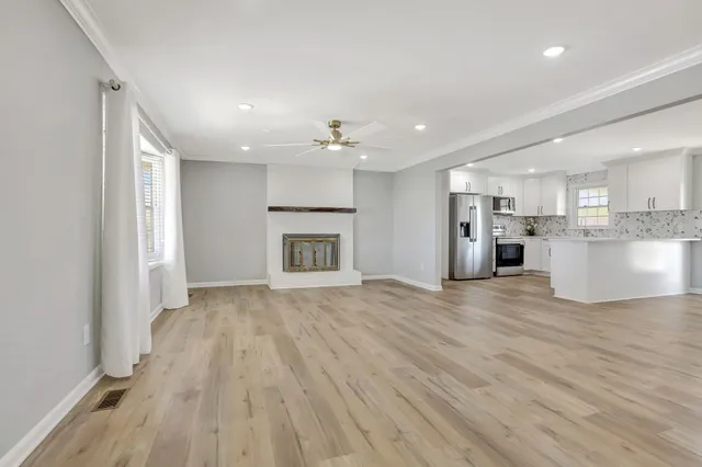 a view of kitchen with a sink and a refrigerator