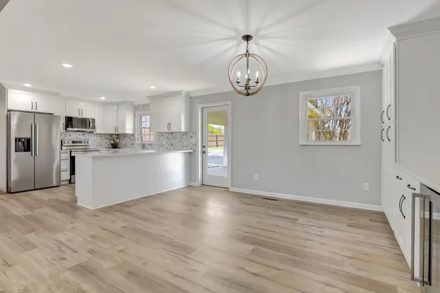 a view of kitchen with cabinets and wooden floor