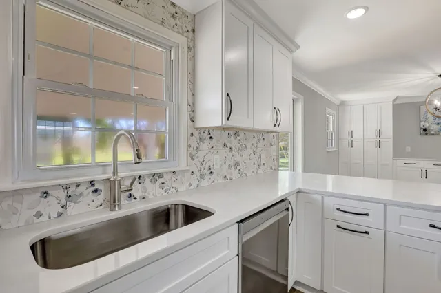 a view white cabinets and sink