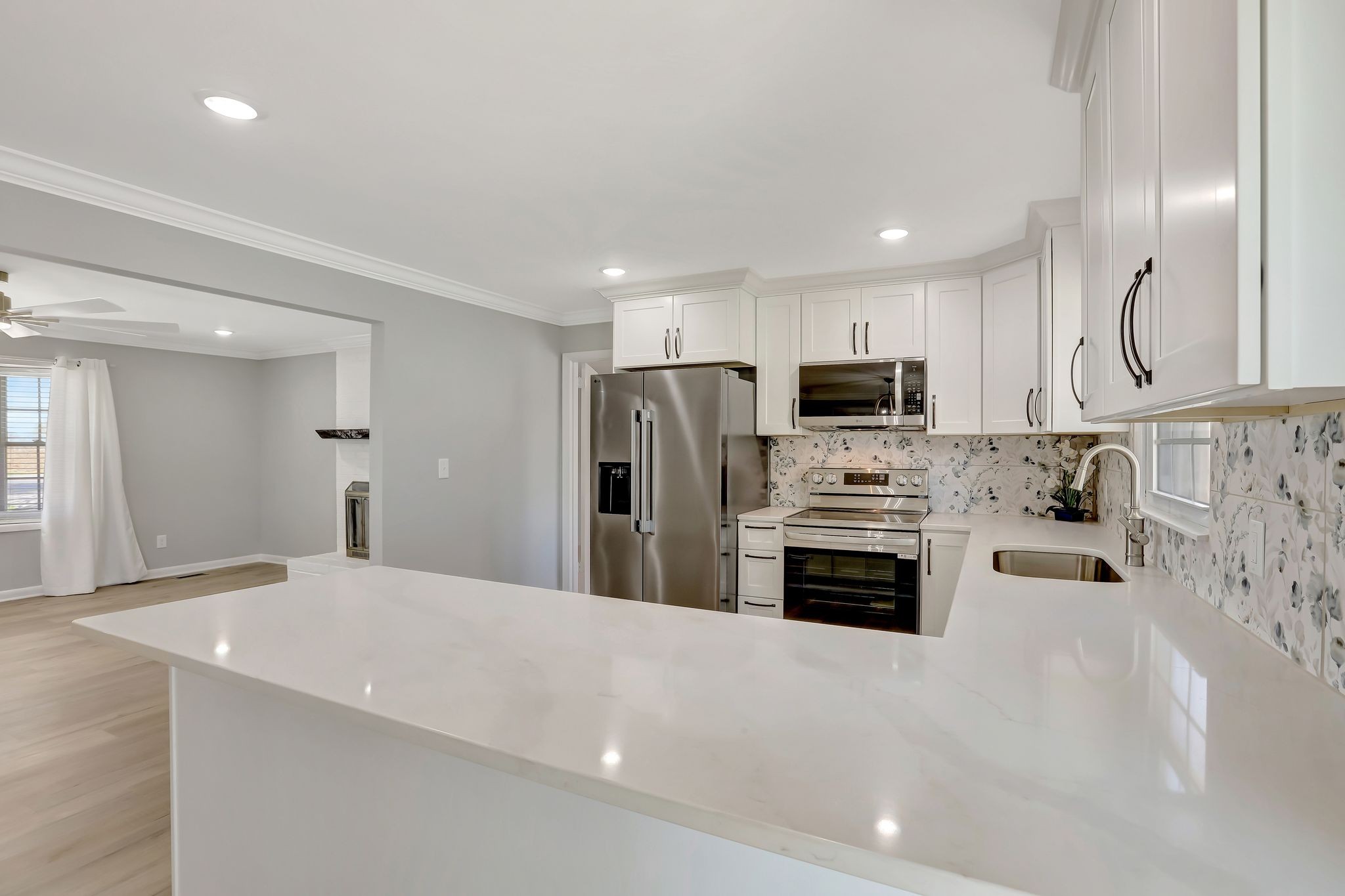 1481 Maxwell Road Belvidere, TN 37306 - Photo 22 of 45 a kitchen with stainless steel appliances a stove a sink a microwave a refrigerator and cabinets