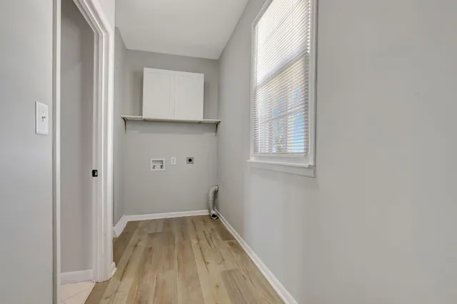 a view of a small space with wooden floor and a window