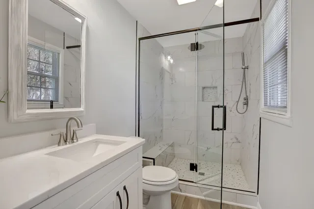 a bathroom with a sink toilet and shower