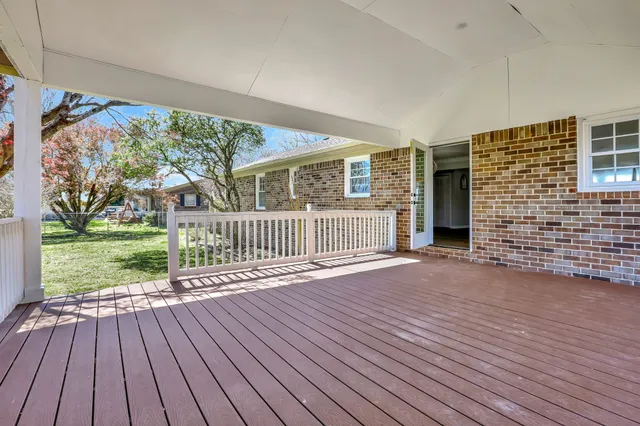 a view of a house with wooden deck
