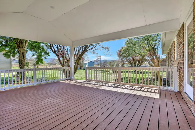 a view of a deck with wooden floor and fence