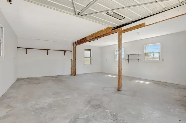 a front view of a house with a garden and yard