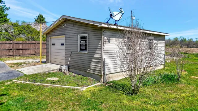 an aerial view of a house with swimming pool outdoor seating and yard